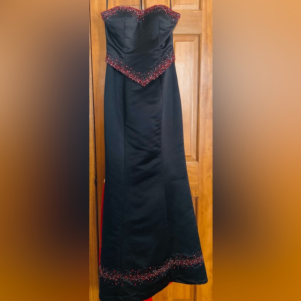 Black formal gown with train and bead detail.